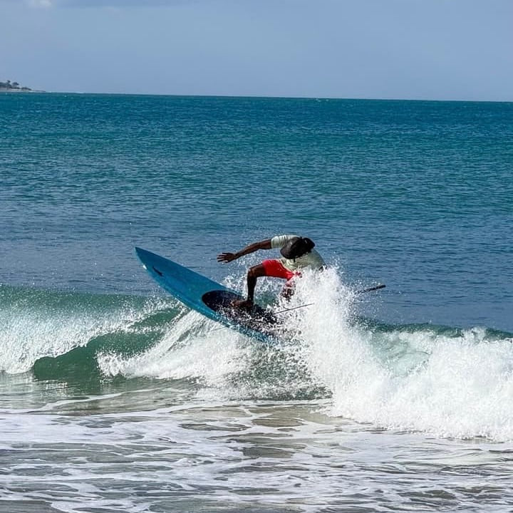 A surfer riding a wave at Arugam Bay