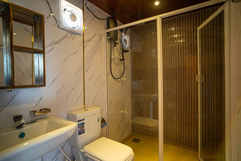 The marble en-suite bathroom with a glass shower