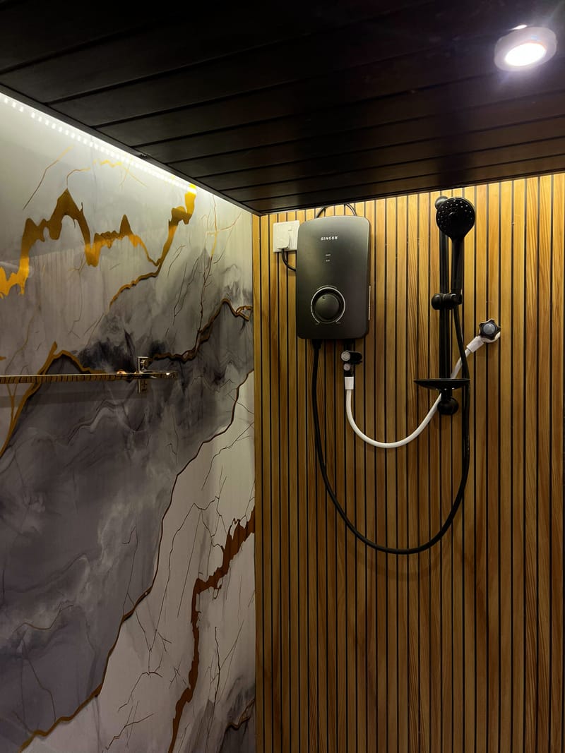 The A-frame villa's shower, with marble and timber-slat walls